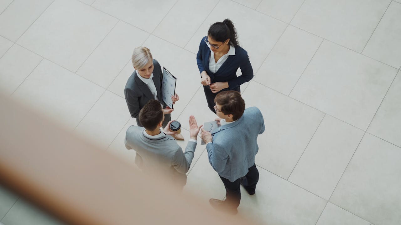 about-us Overhead shot of diverse business team discussing a project indoors.